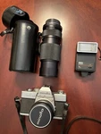 Minolta Srt 100X 35MM Slr Camera W/two Lens And Flash. Fixed Price $89.00.