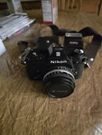 Vintage Nikon Em 35MM Film Slr Camera With 50MM Lens,flash,strap, And Case. Fixed Price $200.00.