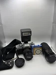 Minolta XG-1 50MM Camera With Promatic CL1800 Flash And 55MM Lens. Fixed Price $40.00.