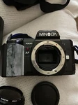 7000 Slr 35MM Camera Black W/ Minolta. 50MM F/1.7 /milisi Elec.flash. Fixed Price $50.00.