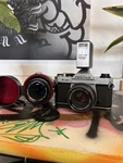 Pentax K1000 Film Camera With 50MM F2.8 Lens And 135MM F3.5. Fixed Price $230.00.