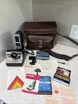 Silver Polaroid Pronto B Instant Film Land Camera + Magic Flash K465. Fixed Price $55.00.