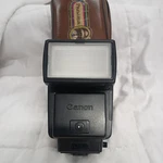 Vintage Canon Speedlite 199A Shoe Mount Flash W/ Carrying Case And Wide Adapter. Fixed Price $55.00.